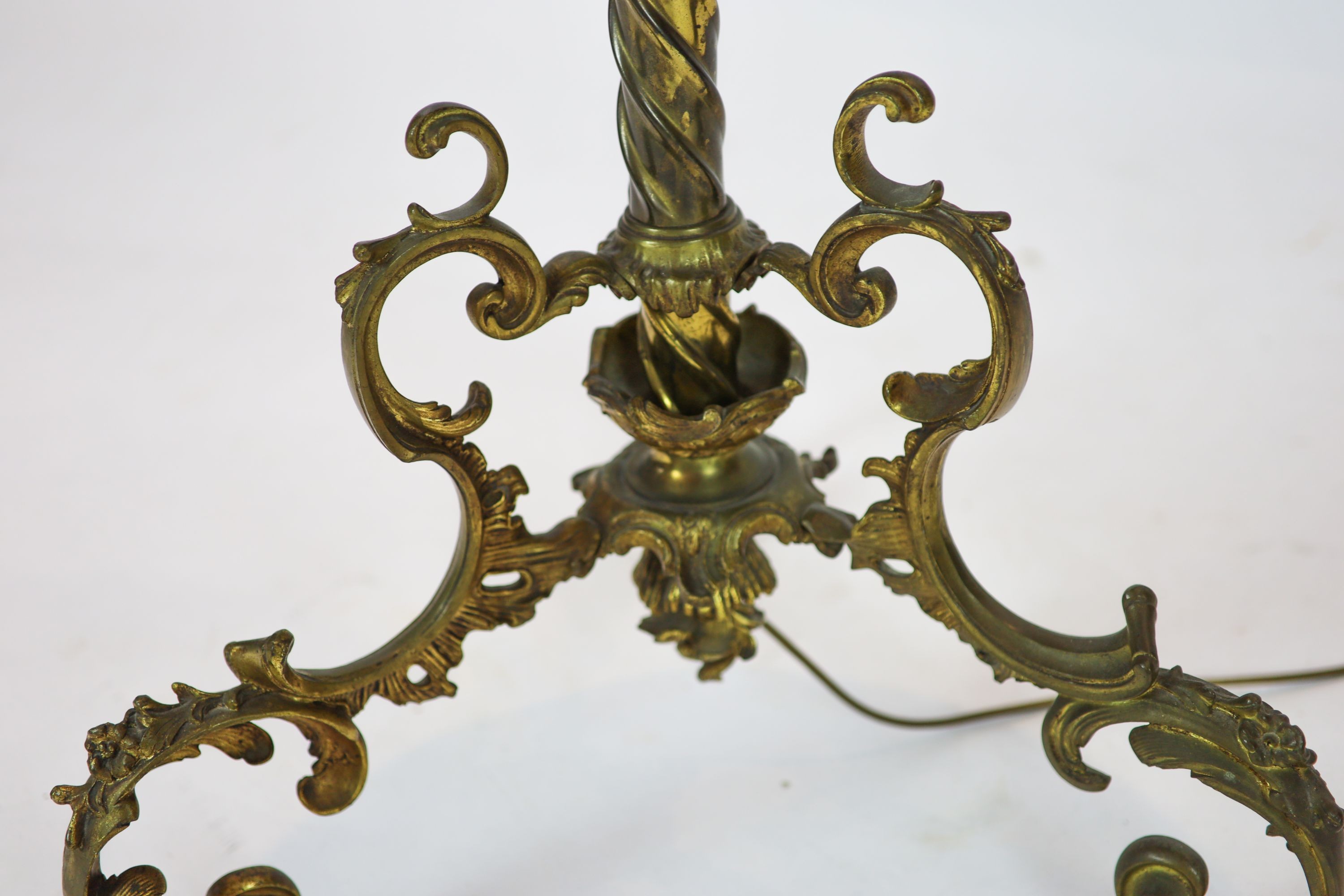 A late Victorian cast brass lamp standard, the column with an alabaster mid tier, raised on an open scrolled tripod base, converted to electricity, height 152cm